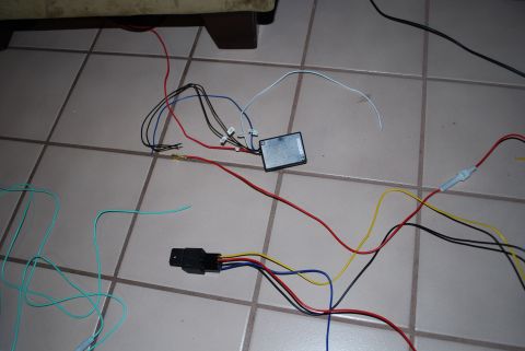 2008 Jeep Wrangler - A collection of electrical wires and components are spread out on a tiled floor. Visible items include a small black box, a black relay soc…