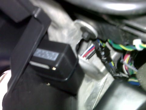 2008 Jeep Wrangler - A black electronic module with a white label is visible, connected to a bundle of colorful wires. This appears to be part of a vehicle's in…