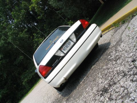 1998 Ford Crown Victoria - The rear of a white 1998 Ford Crown Victoria is shown parked on a gravel surface.