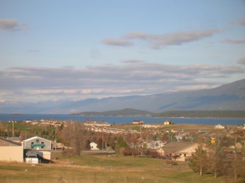 1996 Ford Bronco - A wide shot of a lake and mountains with a small town in the foreground.