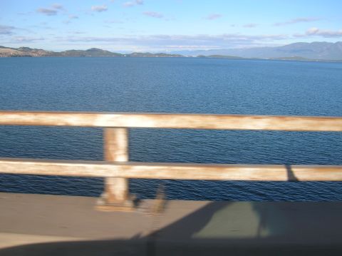 1996 Ford Bronco - A wide shot of a body of water with mountains in the distance, viewed from behind a railing.
