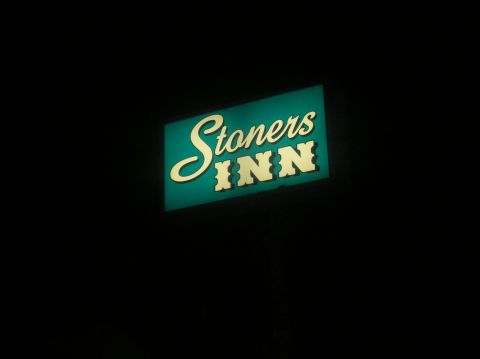 1996 Ford Bronco - A neon sign reads "Stoners INN" in white script and block letters on a teal background. The sign is illuminated against a black background.