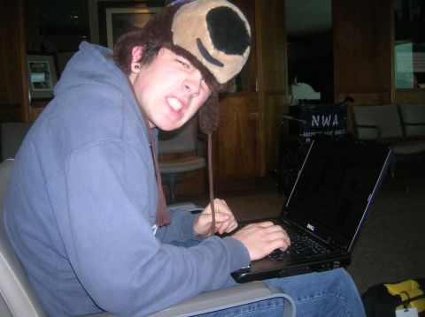 1996 Ford Bronco - A person wearing a fuzzy bear hat is sitting and typing on a laptop computer.