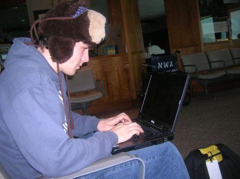 1996 Ford Bronco - A person wearing a fuzzy brown hat with ear flaps is sitting and typing on a black Dell laptop. The person is wearing a blue hoodie and jea…