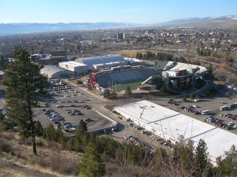1996 Ford Bronco - An aerial view of a stadium and surrounding buildings with a city and mountains in the background.