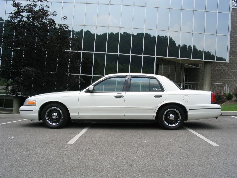White 1998 Ford Crown Victoria sedan parked in a lot, side view