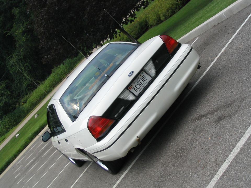 Rear view of a white 1998 Ford Crown Victoria with a KC8ERP license plate