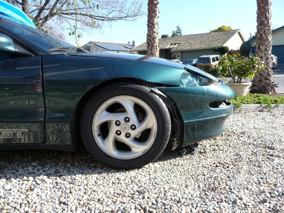 1996 Ford Probe, dark green, front driver's side view, damaged fender and hood.