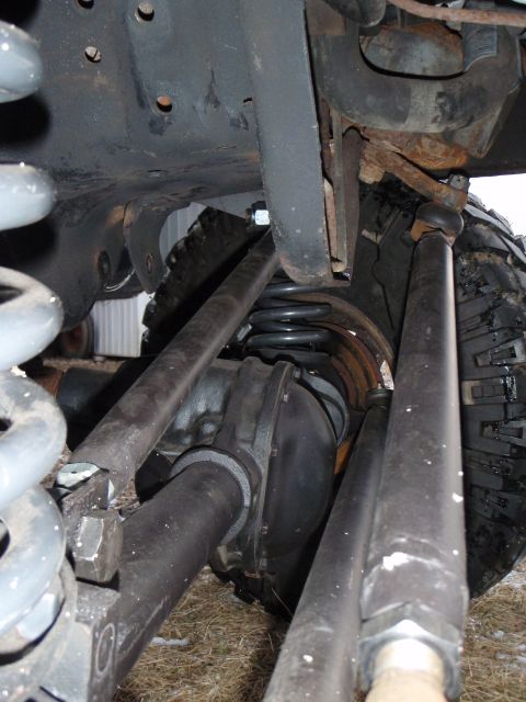 1996 Ford Bronco - A close-up view of the underside of a 1996 Ford Bronco's suspension system, showing the differential, coil springs, and control arms.