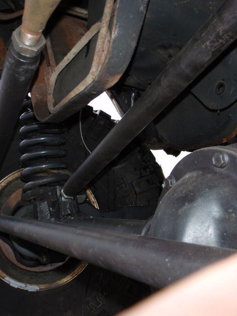 1996 Ford Bronco - Underside view of a vehicle's suspension system, showing a coil spring, shock absorber, and steering linkage. The components appear to be f…