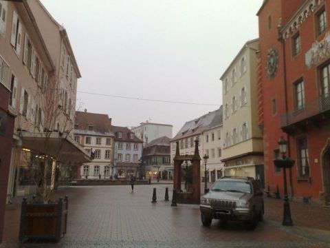 1991 Ford LTD Crown Victoria - Photograph of an SUV in a European town square, not a technical document.