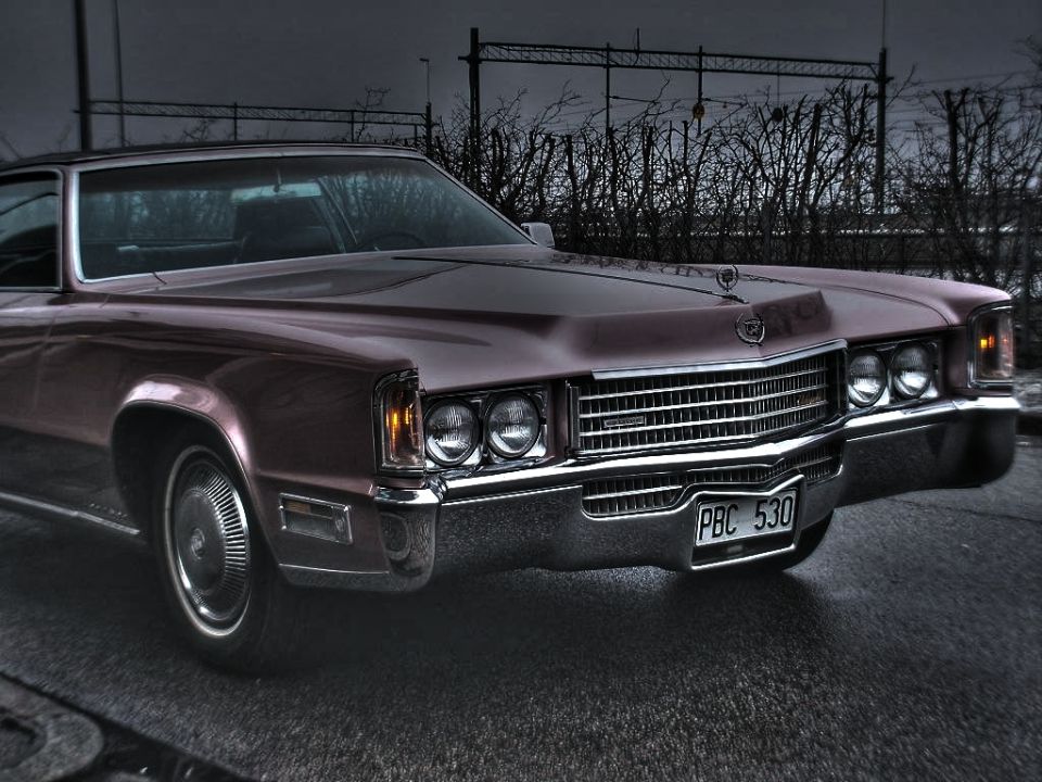 Front view of a maroon 1971 Cadillac Eldorado with a chrome grille and quad headlights. License plate reads PBC 530