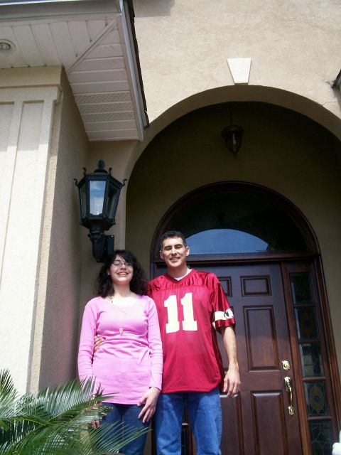 1993 Ford Bronco - A couple poses for a photo in front of a home's entrance.