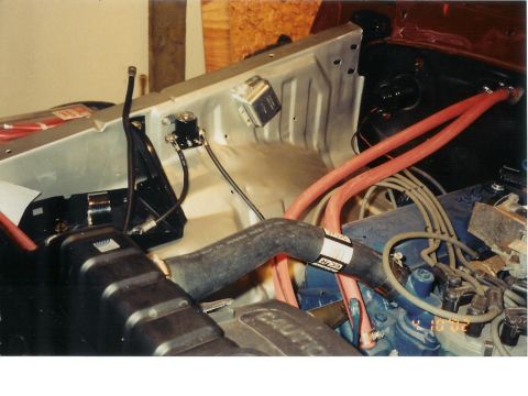 1978 Ford Bronco - Close-up view of a vehicle's engine bay, showing various hoses and electrical components.