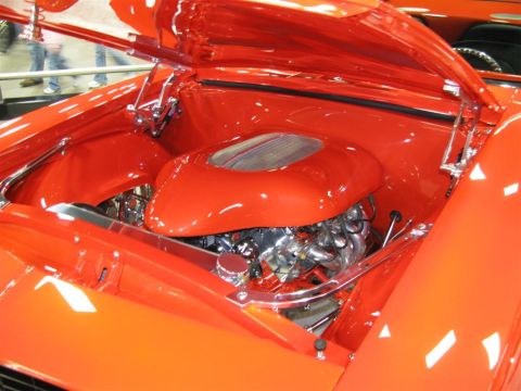 2003 Mercury Marauder - Engine bay of a custom red car, chrome components and a prominent air intake system.