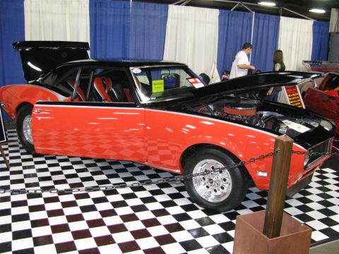 2003 Mercury Marauder - Customized muscle car with racing seats and hood open is displayed at an auto show.