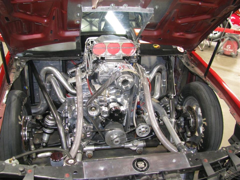 Custom supercharged V8 engine with chrome headers and intake