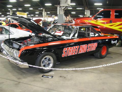2003 Mercury Marauder - A customized muscle car with racing stripes and text is displayed indoors with other vehicles.