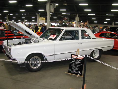 2003 Mercury Marauder - A white 1967 AMC AMX Pro Street is displayed indoors, with its hood open and a descriptive sign nearby.