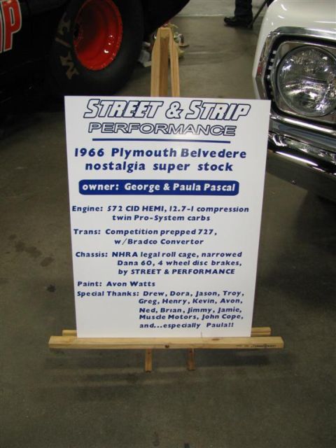 2003 Mercury Marauder - A sign describes the specifications of a 1966 Plymouth Belvedere, including its engine, chassis, and owner.