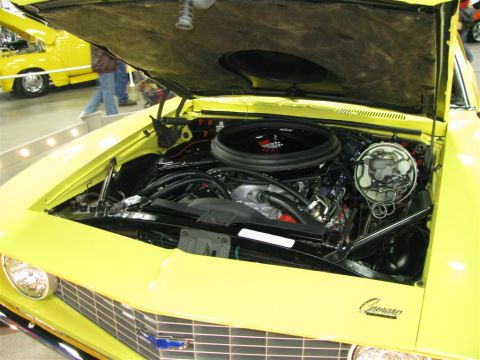 2003 Mercury Marauder - The engine bay of a yellow 1969 Chevrolet Camaro is displayed, a prominent air cleaner and chrome accents.