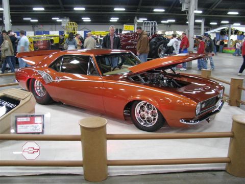 2003 Mercury Marauder - Customized 1967 Camaro on display at a car show with its hood open.