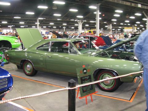 2003 Mercury Marauder - Green 1969 Dodge Super Bee on display at a car show, with multiple other vehicles present.