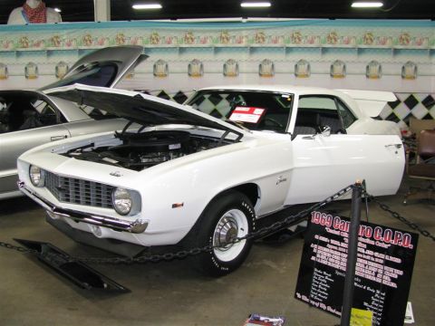 2003 Mercury Marauder - A white 1969 Camaro COPO is displayed with its hood and door open, accompanied by a descriptive sign.