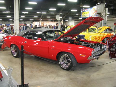 2003 Mercury Marauder - A red 1970 Dodge Challenger R/T is displayed indoors with its hood open, revealing the engine bay.