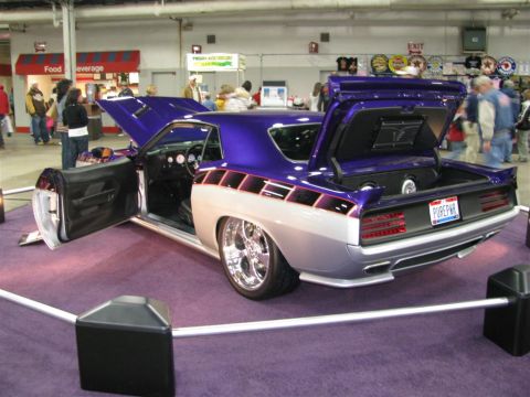 2003 Mercury Marauder - A custom coupe with a two-tone purple and silver paint scheme is displayed with its doors and trunk open, revealing its interior and audio…