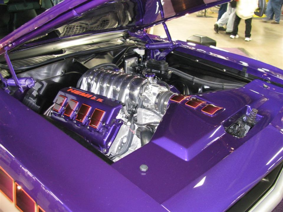 Purple car engine bay with a chrome intake and HEMI 6.1 valve covers