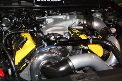 2003 Mercury Marauder - Close-up of a modified engine bay a prominent turbocharger and custom yellow accents.
