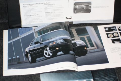 2003 Mercury Marauder - Brochure page displays a black 2003 Mercury Marauder sedan in a 3/4 front view, with another vehicle in the background.