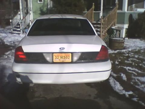 2000 Ford Crown Victoria - Rear view of a white 2000 Ford Crown Victoria, showing its taillights and license plate.