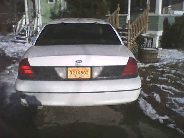 White 2000 Ford Crown Victoria rear view with Illinois license plate 321K502