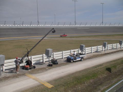 1993 Ford C-350 (Centurion Conversions) - Daytona International Speedway scene with a camera crane and a golf cart on the trackside.