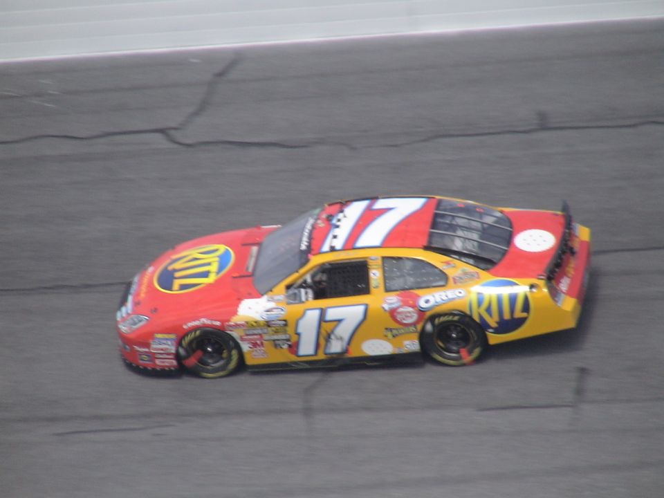 Red and yellow race car with number 17, on a track