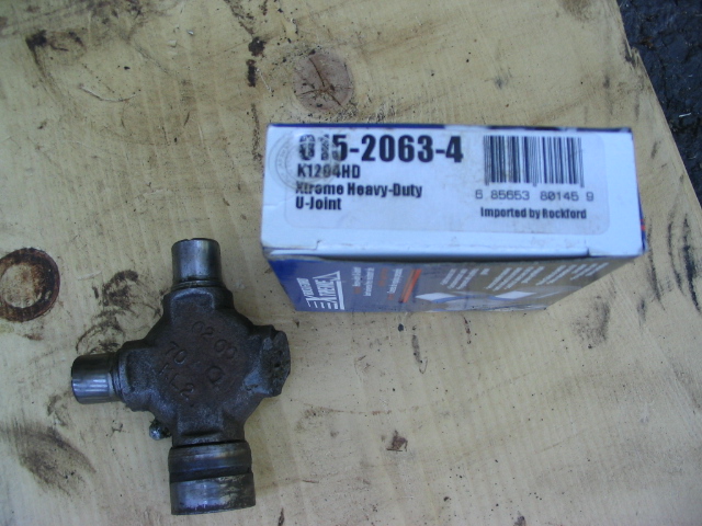 U-joint part next to its box labeled 015-2063-4 Xtreme Heavy-Duty U-Joint