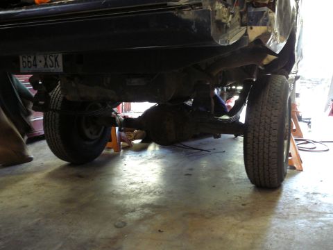 1991 Ford Bronco - The underside of a vehicle is shown with its rear axle and suspension components visible.