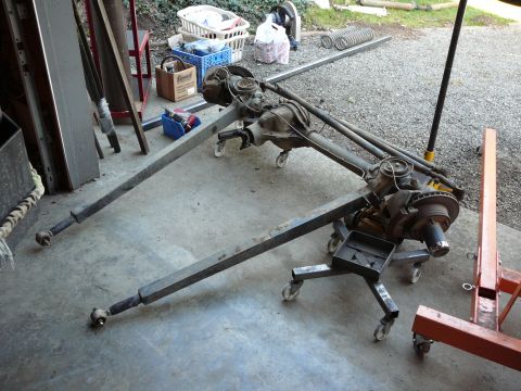 1991 Ford Bronco - Vehicle axles and suspension components are shown on rolling stands, possibly for repair or modification.