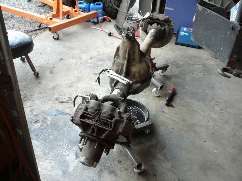 1991 Ford Bronco - A differential axle assembly is shown on a stand in a workshop environment.