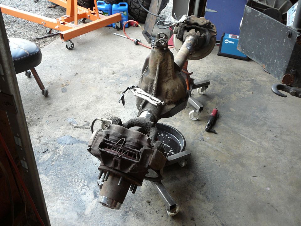 Differential axle assembly on a stand, with brake calipers and rotors attached