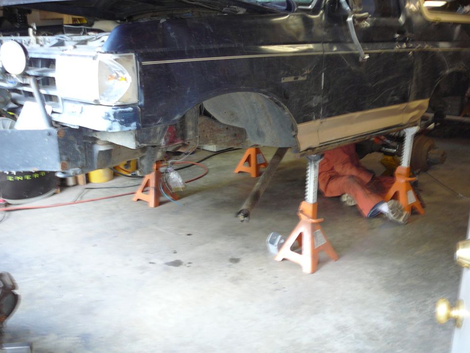 Black 1991 Ford Bronco front end on jack stands, undergoing repairs