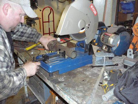 1991 Ford Bronco - A driveshaft is being cut on a Ryobi metal cutting saw.