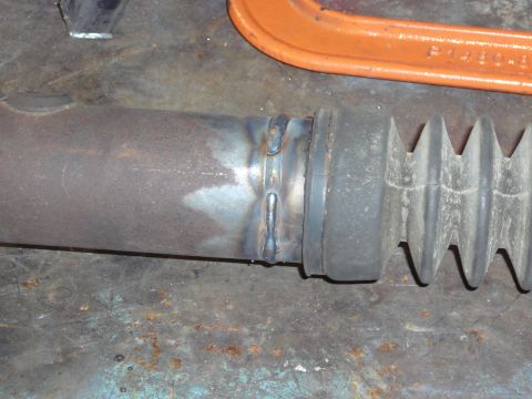 1991 Ford Bronco - Close-up of a welded metal pipe with a rubber bellows boot, likely a component from a vehicle's drivetrain or exhaust system.
