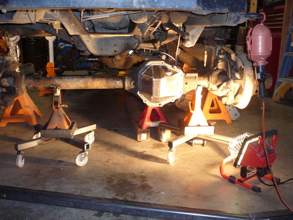 Undercarriage of vehicle on jack stands, showing differential cover