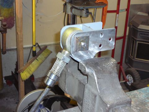 1991 Ford Bronco - A custom metal bracket assembly, likely for a vehicle modification, is secured in a vise for work.