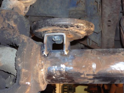1991 Ford Bronco - Custom bracket welded onto a vehicle's axle tube, likely for suspension modification.
