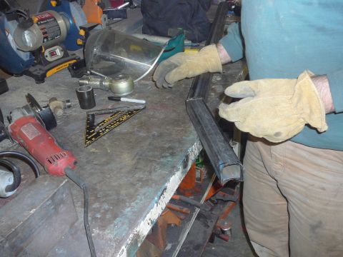 1991 Ford Bronco - Tools and metal parts are laid out on a workbench, ready for fabrication.