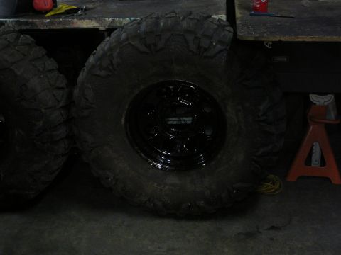 1991 Ford Bronco - A close-up view of a large off-road tire and wheel assembly.